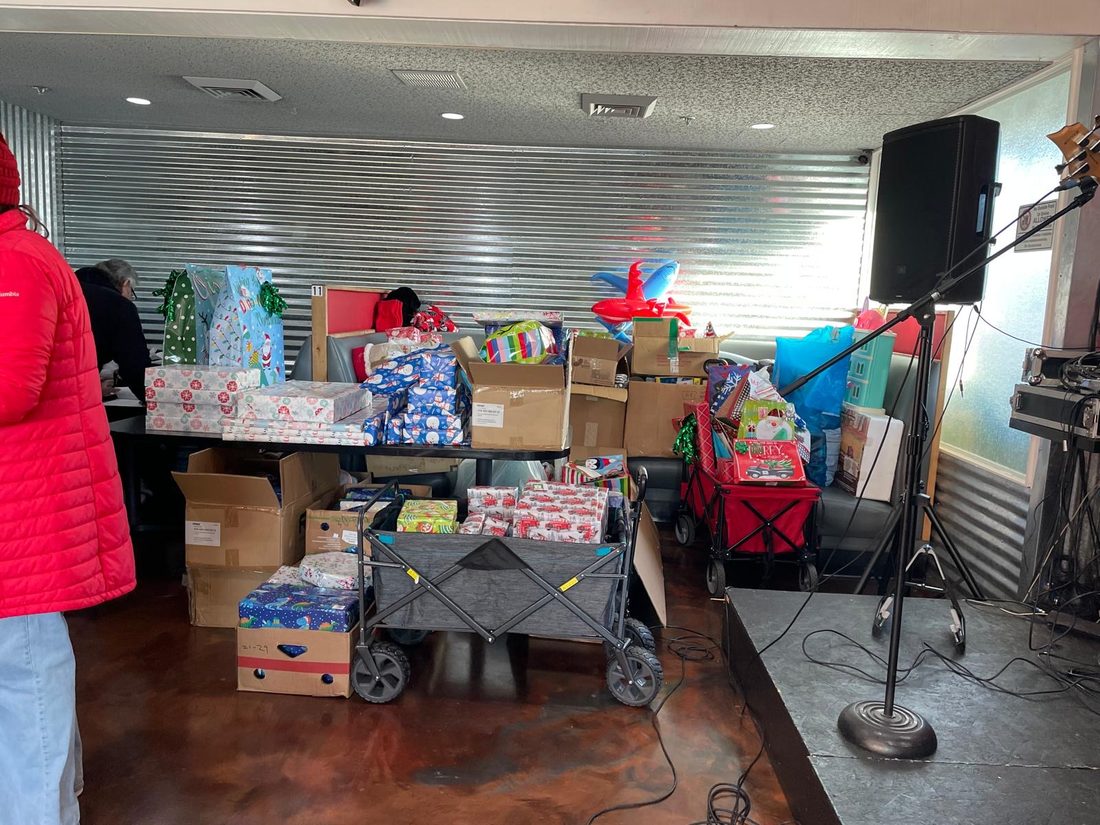 Wrapped gifts and donated supplies ready to share
