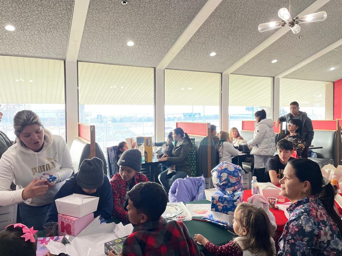 Volunteers handing out gifts to children and families